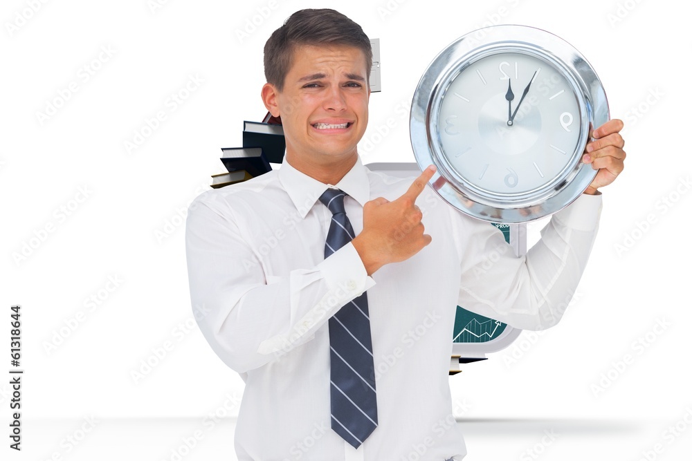Composite image of anxious businessman holding and showing a Composite image of anxious businessman holding and showing a