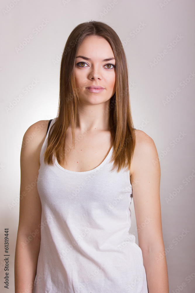 Portrait of a beautiful young woman in a white T-shirt Portrait of a beautiful young woman in a white T-shirt