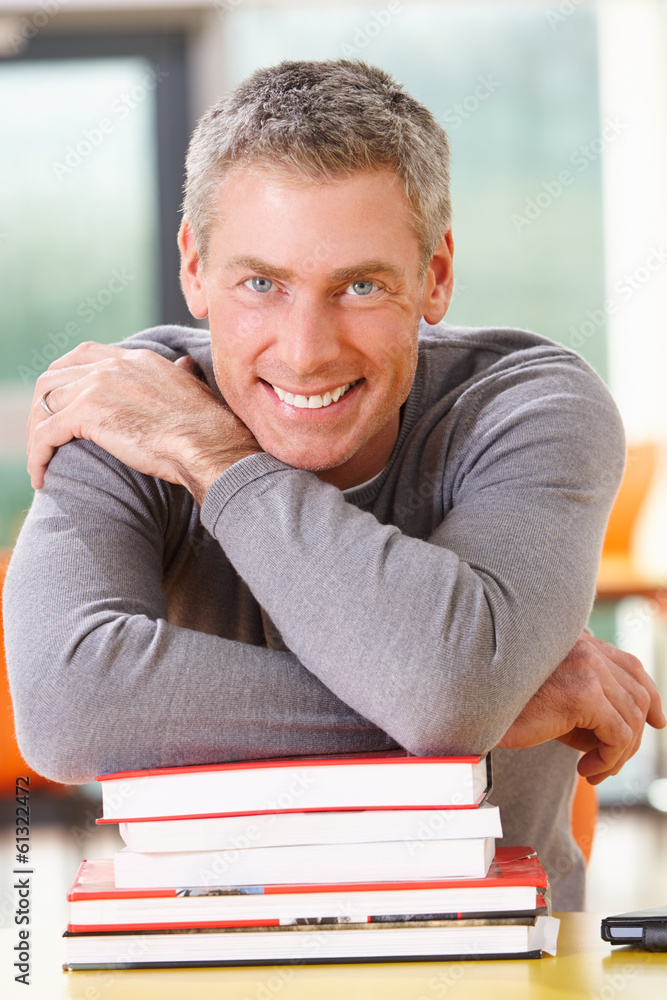 © micromonkey - Male Mature Student Studying In Classroom With Books © micromonkey - Male Mature Student Studying In Classroom With Books