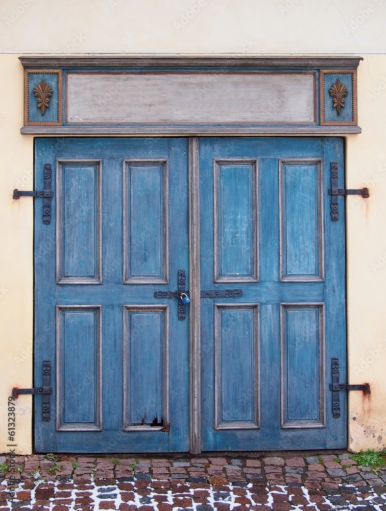 Old blue antique wooden door with padlock.