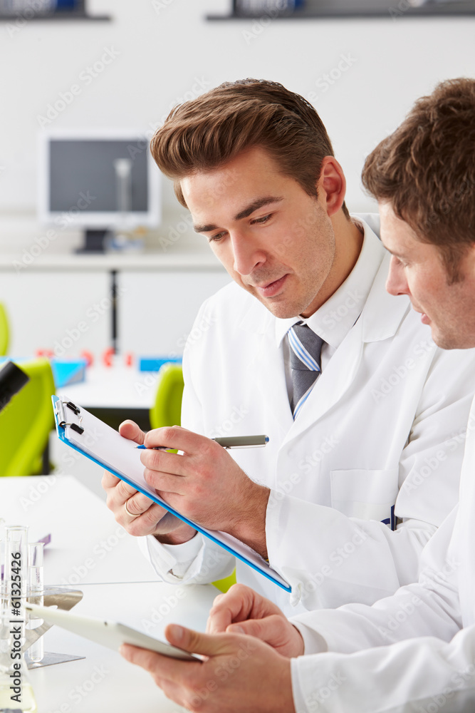 Two Technicians Working In Laboratory Two Technicians Working In Laboratory