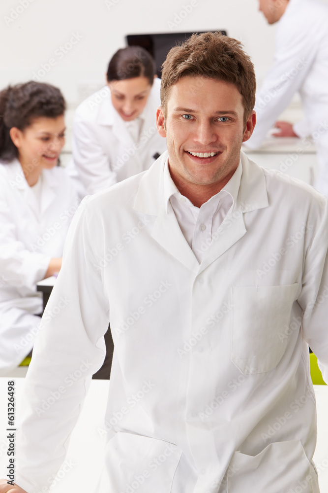 Portrait Of Technician In Laboratory With Colleagues Portrait Of Technician In Laboratory With Colleagues