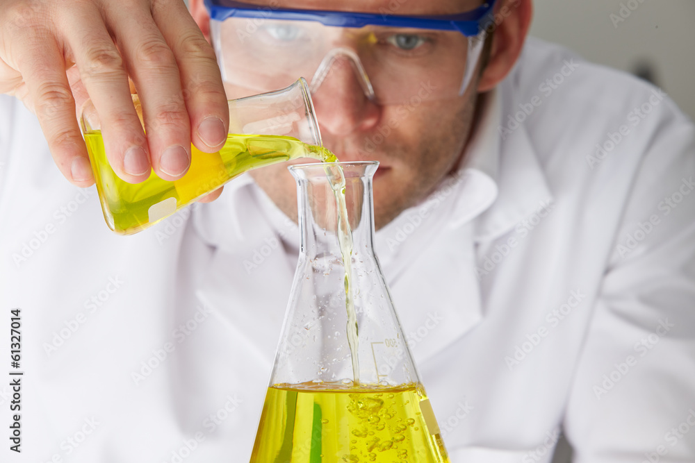 Scientist Pouring Liquid Into Flask Scientist Pouring Liquid Into Flask