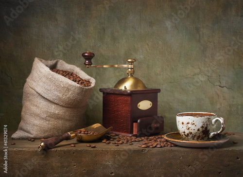 Still life with cup of coffee and grinder