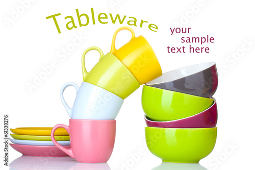 Bright empty bowls, cups and plates isolated on white