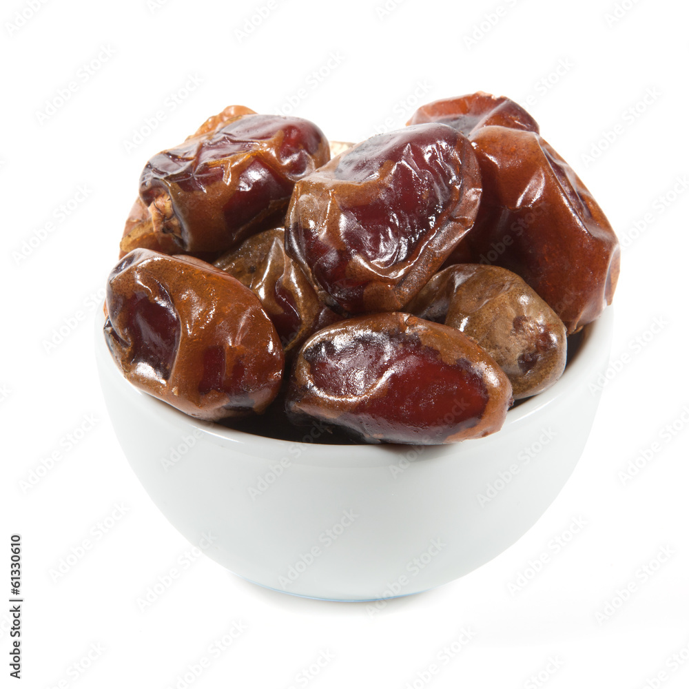 Dried dates in white cup isolated on white Dried dates in white cup isolated on white