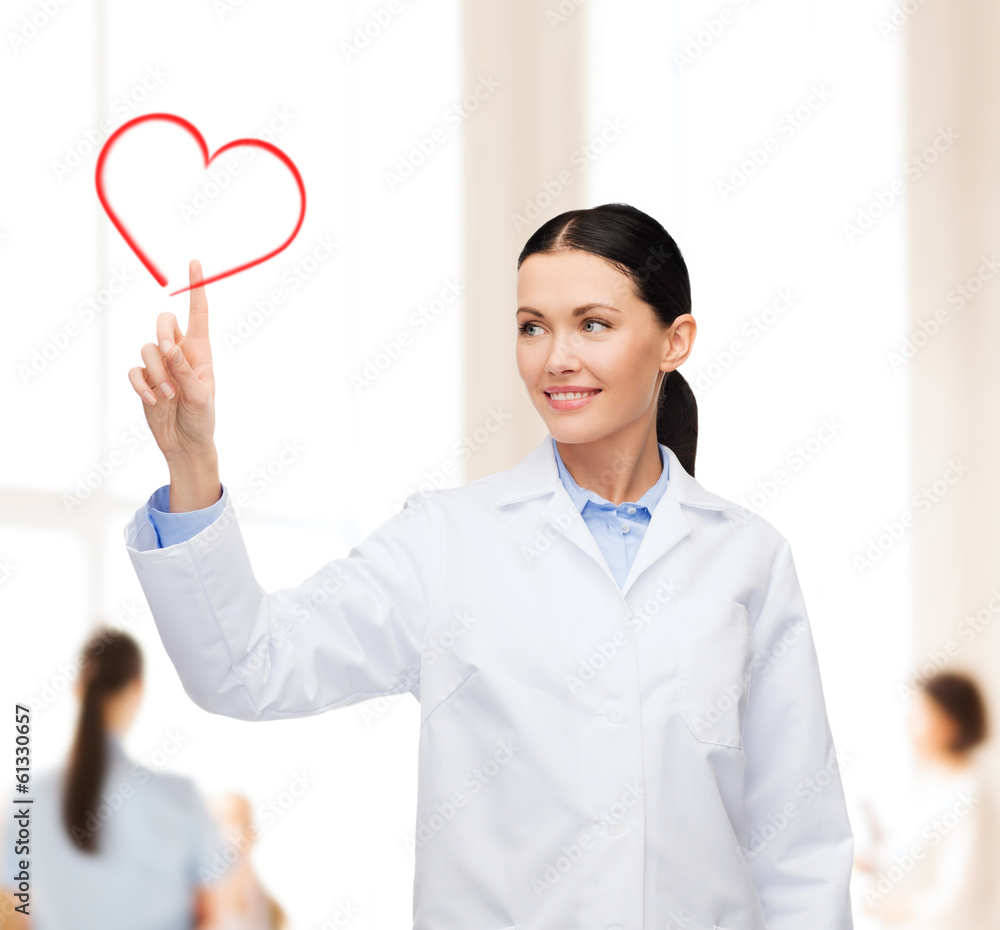 smiling female doctor pointing to heart smiling female doctor pointing to heart