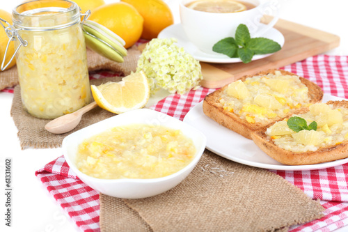 Delicious toasts with lemon jam on plate on table close-up