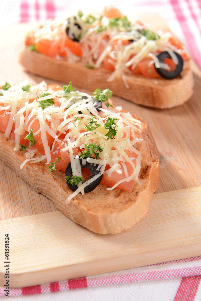 Delicious bruschetta with tomatoes on cutting board close-up Delicious bruschetta with tomatoes on cutting board close-up