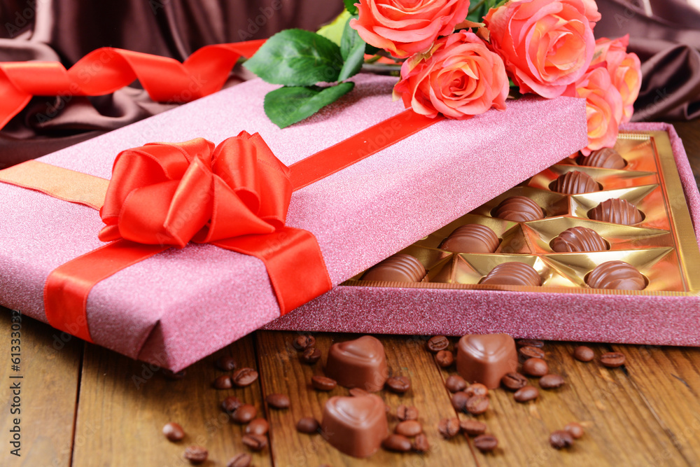 Delicious chocolates in box with flowers Delicious chocolates in box with flowers