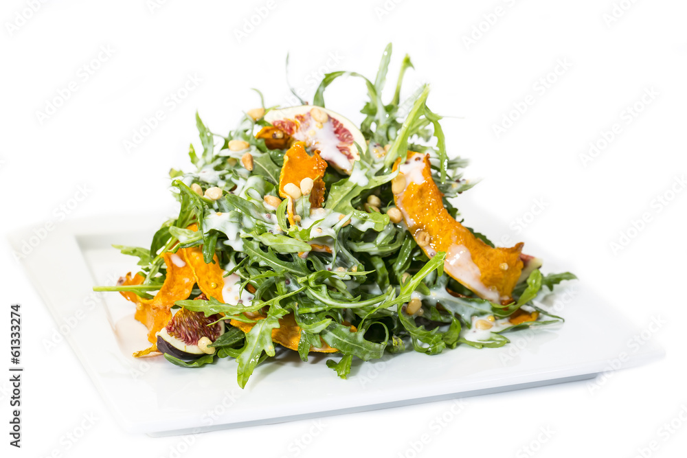 salad of arugula figs and cheese on white background salad of arugula figs and cheese on white background