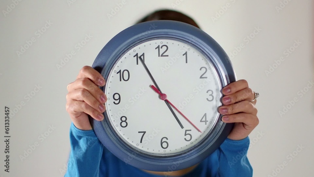 asian girl hiding behind big clock asian girl hiding behind big clock