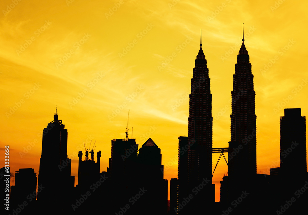 Naklejka premium Silhouette of KLCC tower during golden sunrise