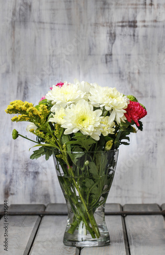 Bouquet of yellow chrysanthemums in glass vase