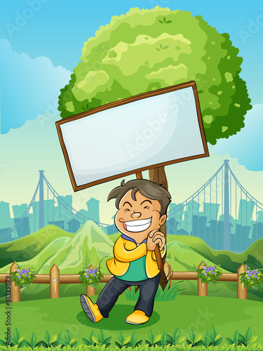 A smiling young man carrying an empty signboard