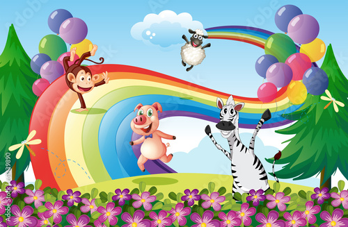 Animals playing at the hilltop with a rainbow