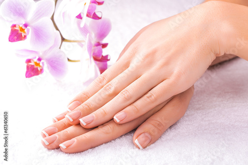 french manicure with pink orchid on the white