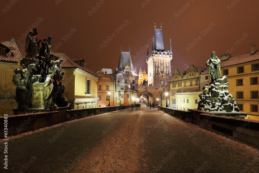Fototapeta premium Night snowy Prague St. Nicholas' Cathedral from Charles Bridge