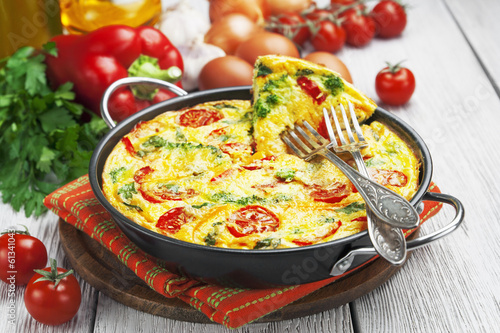 Omelet with vegetables and cheese. Frittata photo