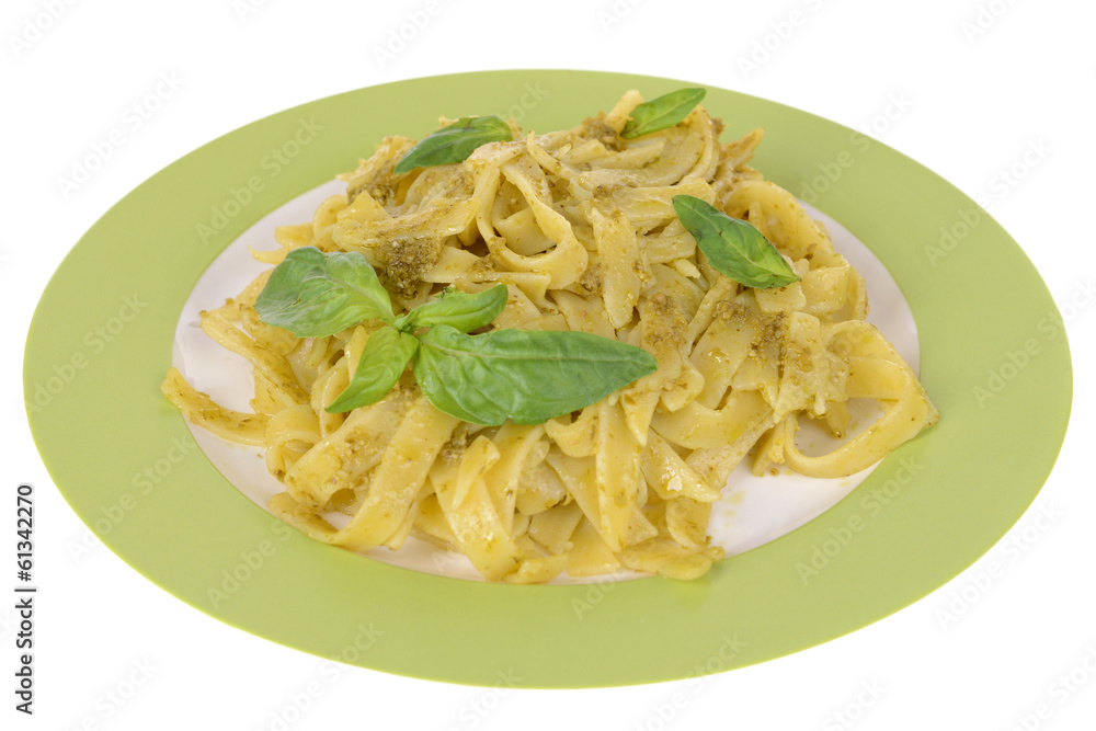 Delicious pasta with pesto on plate isolated on white