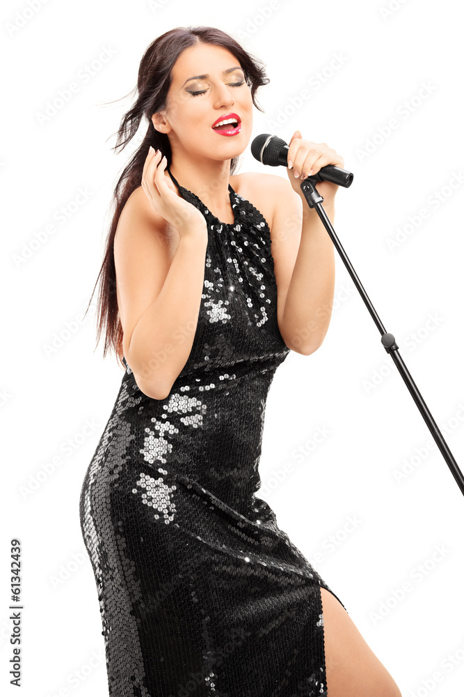 Beautiful woman in black dress singing on microphone Beautiful woman in black dress singing on microphone