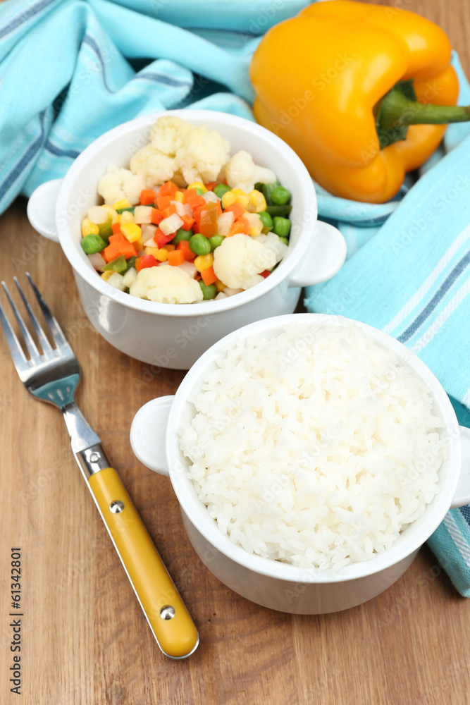 Cooked rice with vegetables on wooden table Cooked rice with vegetables on wooden table