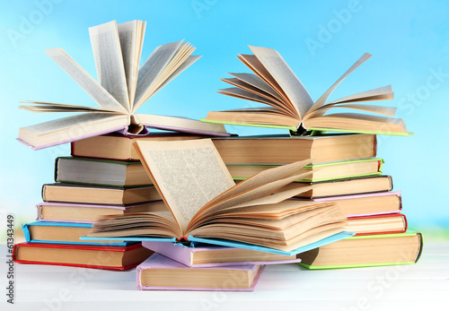 Stacks of books on table on natural background © Africa Studio