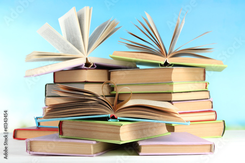 Stacks of books on table on natural background