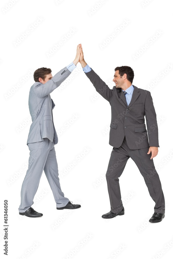Unified business team high fiving each other Unified business team high fiving each other