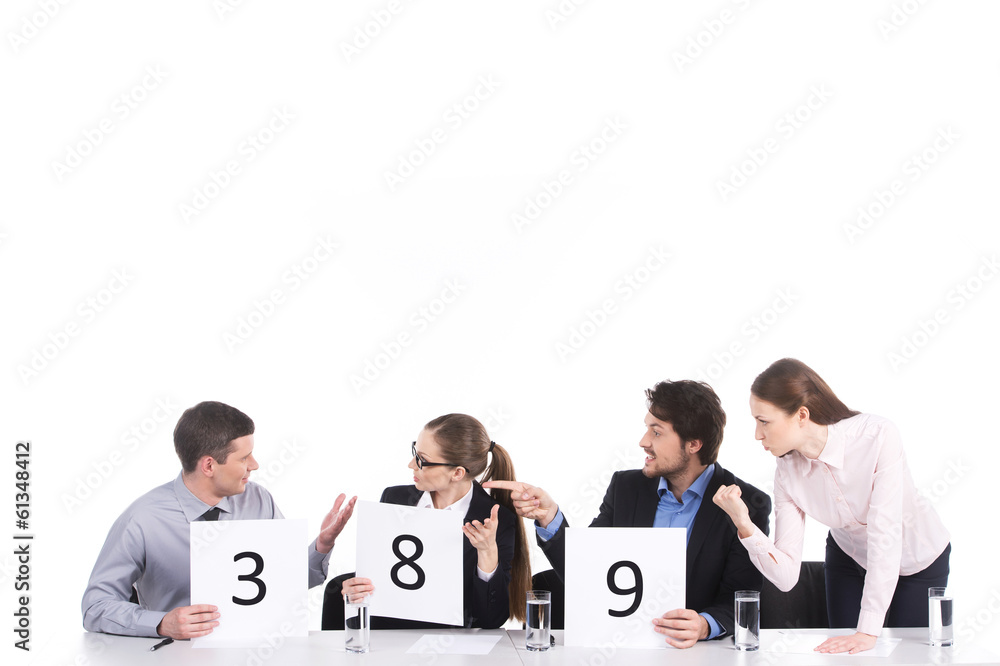 Obraz premium heated teamwork and discussion in group of four.