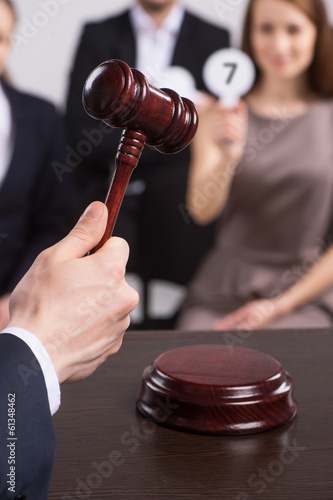 beautiful girl sitting on stool and hold card.