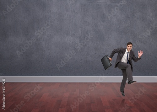 Composite image of happy businessman in a hury © WavebreakMediaMicro