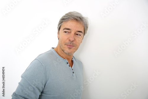 Mature handsome man standing on white background