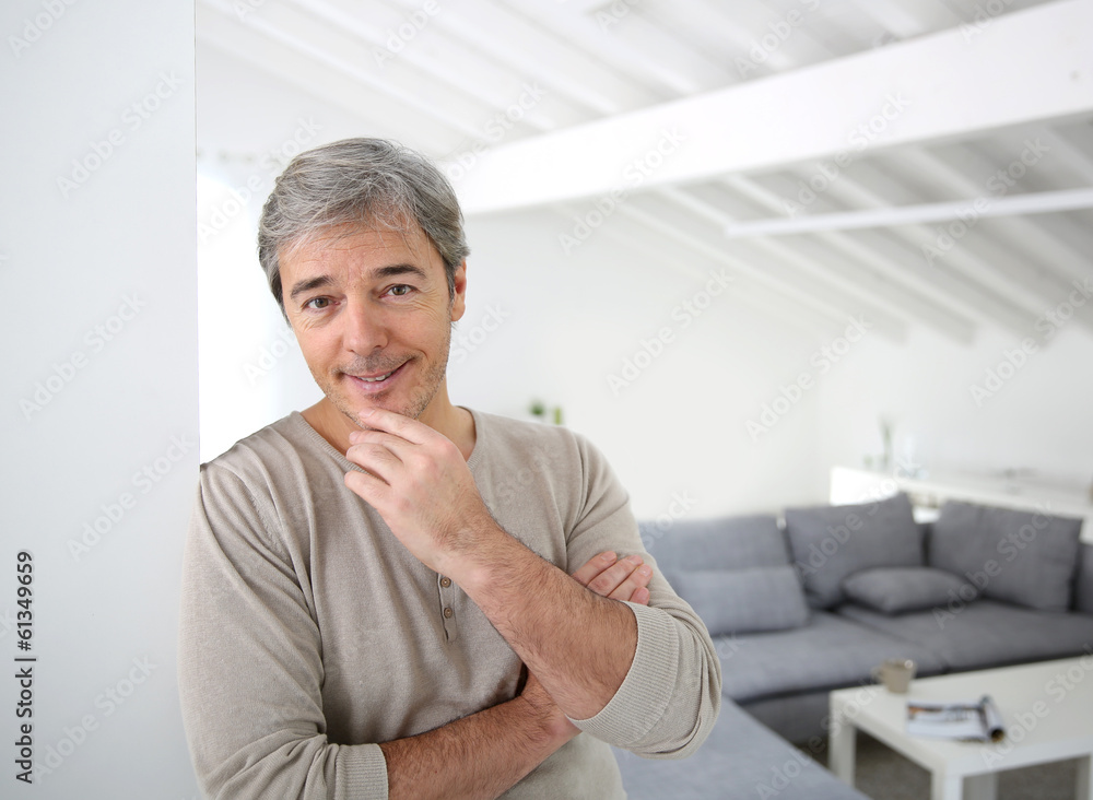 Mature handsome man standing in modern house Mature handsome man standing in modern house