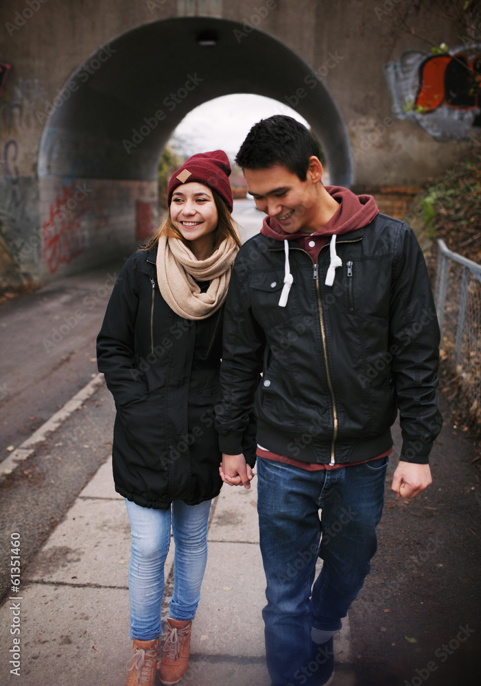 Loving young couple walking on a street