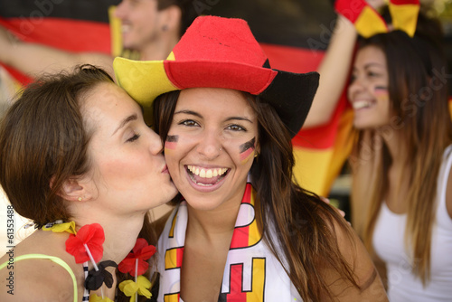 German couple of soccer sport fans kissing celebrating.