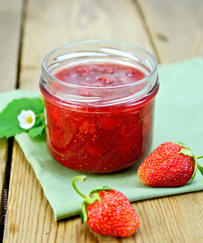 Jam of strawberry with berries on a board Jam of strawberry with berries on a board