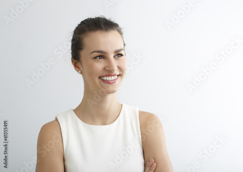 Beautiful young woman smiling against white background.