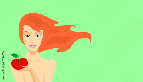 Redhead beauty holding a red apple in her hand