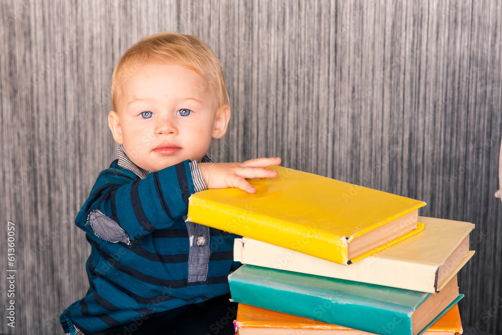 Adorable baby boy with a pile of books Adorable baby boy with a pile of books