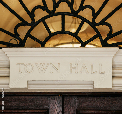 Town Hall sign carved in stone above a wooden door. photo
