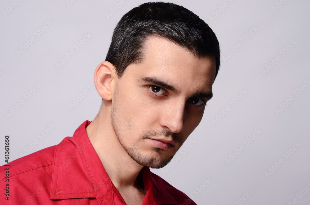 Close up on portrait of a handsome business man in a red shirt. Close up on portrait of a handsome business man in a red shirt.