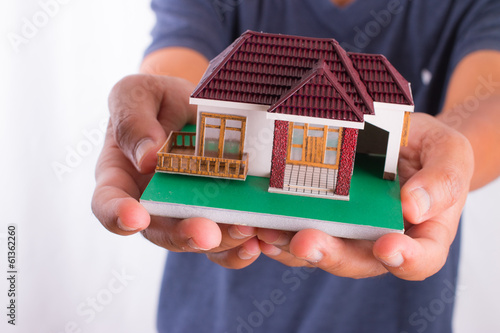 Man holding house model