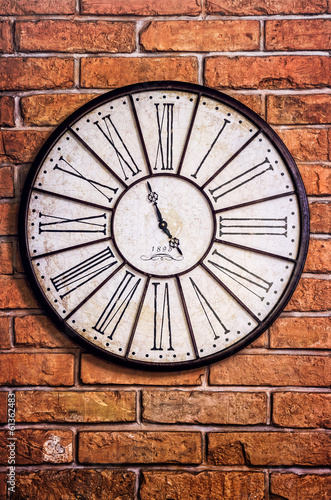 Old vintage clock on textured brick wall