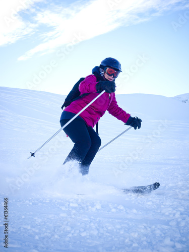 Female skier with helmet in the Austrian Alps