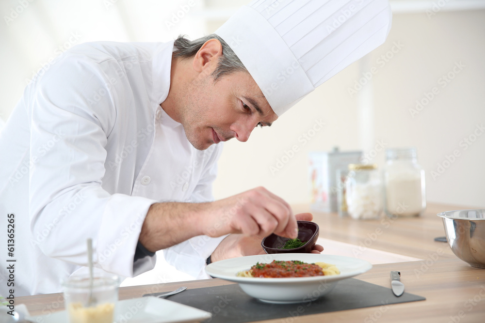 Chef in kitchen preparing italian dish Chef in kitchen preparing italian dish