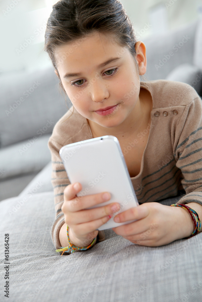 Little girl playing with smartphone at home Little girl playing with smartphone at home