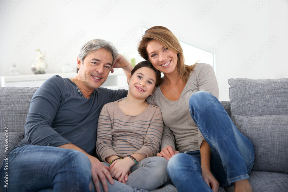 Happy family of three relaxing in sofa Happy family of three relaxing in sofa
