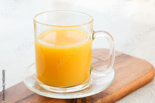 A cup of juice on a wooden board