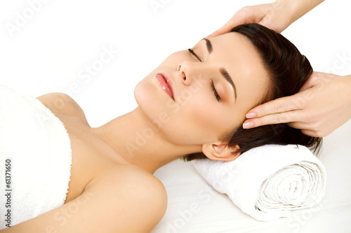 Face Massage. Beautiful Young Woman Getting a Beauty Treatment 